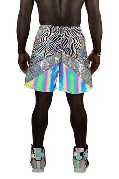 Our Galactic Jungle Shorts feature an elastic waistband and two side zipper pockets to ensure your stuff stays safe when you're having fun at festivals and parties. This pair has three panels including one in holographic flip sequins and one in our signature Photobomber fabric that reflects light and glows rainbow in photos or when the light hits it. Limited edition! When they sell out they are gone forever! Size and Fit: Depending how you want them to fit, each size is capable of suiting a rang Rave Style Festival Bottoms, Short Cut, Rave Style Short Festival Bottoms, Rave Style Summer Streetwear Bottoms, Rave Style Festival Shorts, Metallic Rave Bottoms For Summer, Rave Bottoms With Built-in Shorts, Metallic Disco Shorts For Summer, Summer Rave Metallic Bottoms, Multicolor Short Rave Bottoms