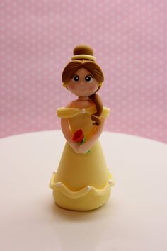 a toy figurine that is sitting on a table with polka dot wall in the background