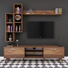 an entertainment center with bookshelves and a flat screen tv mounted on the wall