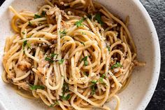 a white bowl filled with pasta and sauce