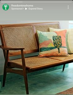 a wooden bench sitting next to a window on top of a carpeted floor in front of a painting