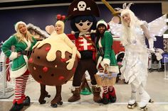 four people dressed up in costumes posing for a photo with an ice cream sundae