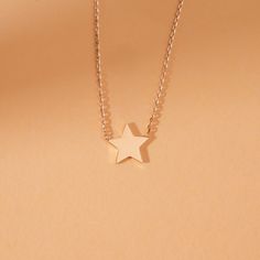 Capella A night sky’s dream. Add a touch of celestial magic to your everyday style with this dainty Mini Star Necklace, crafted entirely in solid gold. This dainty piece features a tiny, gleaming star pendant suspended on a shimmering chain, catching the light with every movement. Wear it on its own for a whisper of understated elegance or layer it with other necklaces for a bolder, personalized look. - Handmade- Solid Gold- Star Size: 8 mm All pieces come beautifully boxed in suede pouches you can always use when traveling! Elegant Star-shaped 14k Gold Filled Jewelry, Elegant 14k Gold Filled Star Jewelry, Delicate 14k Gold Jewelry With Star Charm, Minimalist Yellow Gold Jewelry With Star Charm, Minimalist Rose Gold Star Charm Jewelry, Rose Gold 14k Gold Star Jewelry, Minimalist 14k Rose Gold Necklace, Elegant 14k Gold Filled Necklace With Star Charm, Elegant 14k Gold-filled Necklace With Star Charm