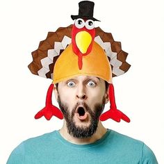 a man with a turkey hat on his head making a surprised face while looking at the camera