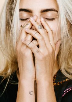 a woman covering her face with both hands