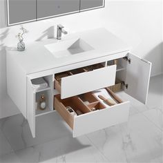 a bathroom vanity with two drawers and a mirror above it that is open to reveal the sink