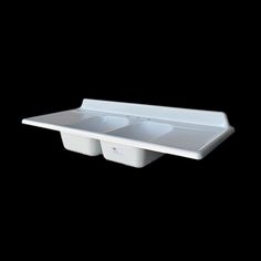 two white dishes sitting on top of each other in the middle of a black background