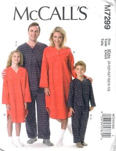 an adult and two children wearing matching pajamas