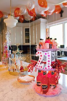 a table topped with bottles of alcohol and balloons