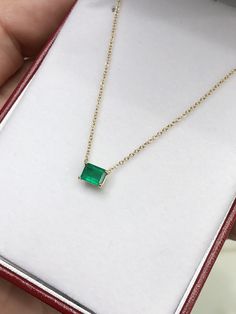 Featured here is a fine quality 0.80-carat stunning, East to West emerald necklace in fine 14K yellow gold. Displayed in the center is a vivacious green emerald with great clarity, accented by a simple four-prong gold mount, allowing for the emerald to be shown in full view. The earth mined, green emerald has a desirable lush green color with excellent qualities. An 18 inch is attached to the emerald pendant. This necklace is ideal for everyday use and is the perfect accessory to any outfit. Tot Emerald Cut Green Diamond Necklace Gift, Dainty Emerald Necklace For Formal Occasions, Green Diamond Cut Necklace For Gift, Emerald Cut Diamond Necklace As A Gift, Green Emerald Necklace, Necklace Emerald, Tiny Bow, Emerald Pendant, Colombian Emeralds