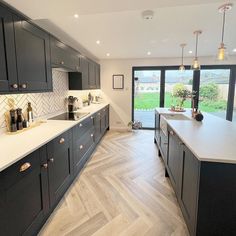 a kitchen with black cabinets and white counter tops