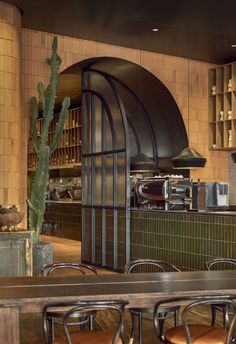 the interior of a restaurant with tables, chairs and an oven in the back wall