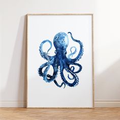 an octopus print hangs on the wall next to a wooden floor