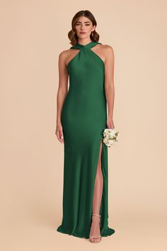 a woman wearing a green dress with high slit