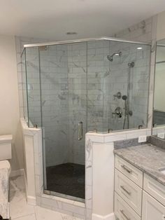 a bathroom with a walk in shower next to a sink