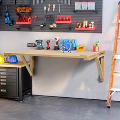 a workbench with tools hanging on the wall