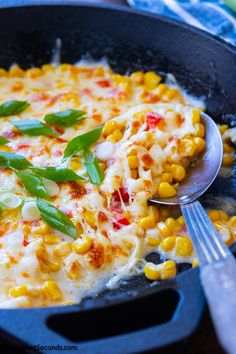 a skillet filled with corn and cheese