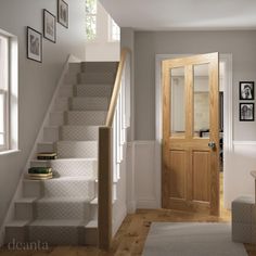 an entryway with stairs leading up to the door and framed pictures on the wall