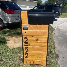 a mailbox sitting in the grass next to a street