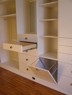 an empty closet is shown with drawers and shelves