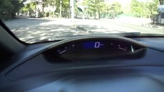 the dashboard of a car on a city street