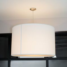 a white lamp hanging from the ceiling in a room