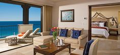 a living room filled with furniture and an ocean view