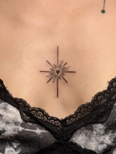 a woman's chest with a star tattoo on it