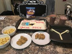 there is a birthday cake and other food on the kitchen counter with it's name written