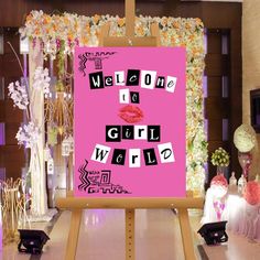 a pink sign with the words welcome to a girl world on it in front of flowers