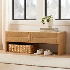 a pair of shoes under a wooden bench in front of a window with white curtains