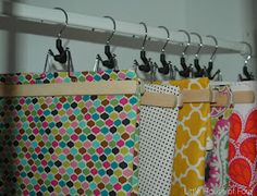 colorful fabric hanging from hooks in a closet