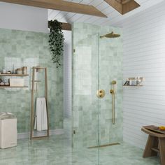 a bathroom with green tiles on the walls and floor, including a walk in shower