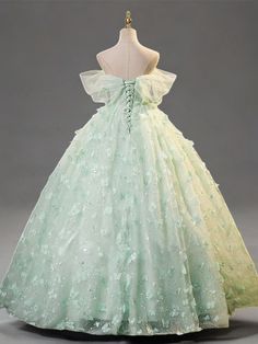 Celebrate elegance in this Mint Green Evening Dress, designed to exude sophistication and grace at every turn. Crafted from layers of soft, mint green tulle, this gown is adorned with exquisite floral appliqués that cascade down its length, adding depth and enchantment to the fabric's gentle flow. The bodice features a structured corset that cinches at the waist, creating a flattering silhouette that celebrates the fullness of plus-size figures. This corset is not only a nod to classic style but also ensures a perfect, tailored fit, enhancing comfort and confidence. The dress's romantic off-shoulder design, complemented by airy butterfly sleeves, frames the neckline beautifully, adding a touch of delicate charm. Flowing effortlessly to a floor-length finish, the skirt swirls with every ste Green Enchanted Dress, Green Organza Evening Dress For Prom, Princess Style Green Ball Gown With Fitted Bodice, Green Floor-length Dress For Quinceanera, Green Ball Gown For Quinceanera, Green Organza Dress For Prom Season, Green Princess Style Dress For Debutante Ball, Green Fitted Bodice Evening Dress For Quinceanera, Green Ball Gown With Fitted Bodice For Prom Season