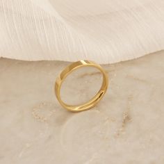 This beautiful gold band ring is a perfect statement piece to be worn alone or layered with other rings. 2.5mm comfort fit band Base Material: High Quality Surgical Steel Finish: 18k Gold over surgical steel Nickel Free and Lead Free Waterproof and tarnish resistant Minimalist Gold Band As Gift, Minimalist Gold Bands For Gifts, Gold Hypoallergenic Midi Rings For Wedding, Gold Tarnish-resistant Promise Ring Bands, Gold Hypoallergenic Rings For Wedding, Minimalist Wide Band Ring Tarnish Resistant For Wedding, Yellow Gold Hypoallergenic Midi Rings For Wedding, Gold Stackable Rings With Thick Band And Smooth Bezel, Gold Thick Band Couple Promise Rings