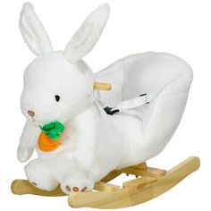 a white stuffed rabbit sitting on top of a wooden rocking toy