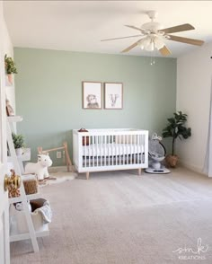 a baby's room with green walls and white furniture