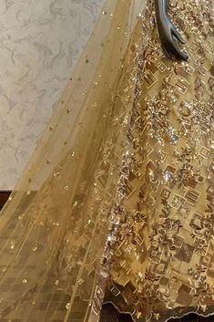 Description : This Lehenga Choli is Ready to Wear Golden attached cancan lehenga with sequin, floral embroidery. Paired with a padded blouse with all over beads, sequins, thread work and dupatta. Details : No of Components: 3 Components: Blouse, Dupatta, Lehenga Pattern: Embroidery Type of Work: Sequins, & Thread Work Neckline: Sweetheart Neck Sleeve Type: Sleeveless Fabric: Net Color: Golden Other Details: Attached inner lining Lehenga Length: 46.5 inches Blouse Chest : 36 Occasion: Bride, Dest Glamorous Floor-length Sharara With Resham Embroidery, Party Wear Semi-stitched Sharara With Sequins, Glamorous Organza Choli With Dupatta, Glamorous Organza Lehenga For Eid, Festive Floor-length Sequined Sharara, Glamorous Organza Sets With Resham Embroidery, Glamorous Anarkali Set With Resham Embroidery, Glamorous Festive Choli With Intricate Embroidery, Semi-stitched Embellished Gold Anarkali Set