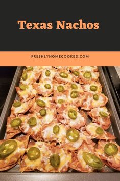 a pan filled with nachos covered in cheese and jalapenos