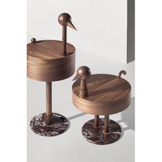 two wooden stools sitting next to each other