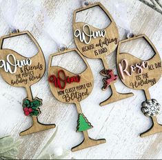 four wine glass ornaments with names on them