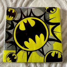 a batman themed napkin on top of a bed