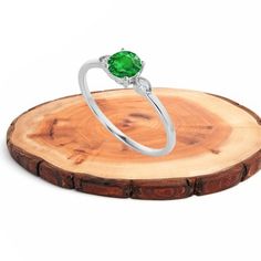 "item description :    this lovely ring is made with pure 925 sterling silver , high quality emerald green diamond is mounted. this ring is made in stacking and minimal format that gives your finger awesome looks since ring is so cute so it is very good gift  your loved ones   Metal : 925 Sterling Silver , our all item are made with solid 925 silver and nickle free so they are skin               friendly.  Stamp : 925  gemstone : created Emerald  birth month : May.    stone size : 6 MM Approx.  Ring size : go to listing drop down menu.  Plating : you can also select GOLD and ROSE GOLD plating for this please go to the Personalisation section.  EMERALD METAPHYSICAL PROPERTY  : Emerald is a life-affirming stone. It opens the heart chakra and calms the emotions. It provides inspiration, balan Dainty Green Solitaire Diamond Ring, Dainty Green Diamond Ring, Dainty Green Diamond Ring With Prong Setting, Green Cubic Zirconia Solitaire Diamond Ring, Green Solitaire Cubic Zirconia Diamond Ring, Green Cubic Zirconia Diamond Promise Ring, Emerald Gemstone Engagement Ring, Green Diamond Rings, Emerald Eternity Band