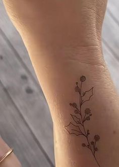 a woman's foot with a small flower tattoo on her left side calfocks