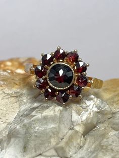 Condition excellent Full uk hallmarking 9ct gold 11 mixed cut garnets bezel and claw set Vintage Garnet Birthstone Rings, Vintage Garnet Rings With Rose Cut Diamonds, Vintage Garnet Cluster Ring For Anniversary, Vintage Garnet Cluster Ring As Gift, Antique 14k Gold Round Flower Ring, Vintage Garnet Cluster Ring With Gemstone, Vintage Round Garnet Cluster Ring, Vintage Garnet Cluster Ring, Antique Round Flower Ring In 14k Gold