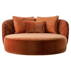 a round couch with two pillows on it