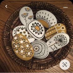 painted rocks in a wicker basket on a table