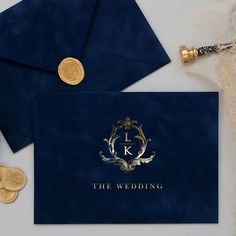 two blue envelopes with gold foil on them