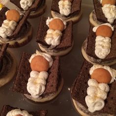 chocolate desserts with whipped cream on top are arranged in the shape of people's heads