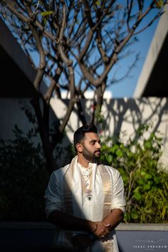 a man standing in front of a tree